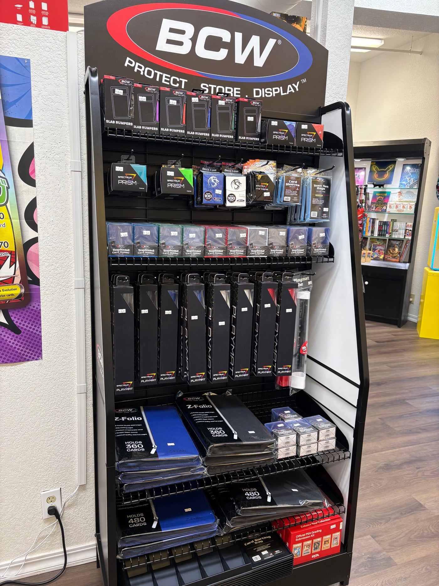 Trading card sleeves and accessories displayed inside Glamorous Gamers